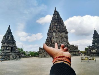 Low angle view of female statue in temple against sky