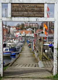 Boats moored at flensburg harbor seen from gate