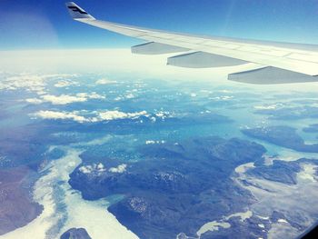 Aerial view of airplane wing over landscape