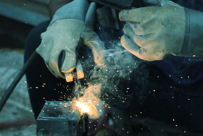 Close-up of man welding metal at workshop