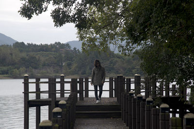 View of a woman on the wooden deck at the seaside