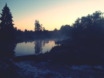 Scenic view of lake at sunset