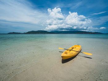 Yellow kayak on sandbar, clear water and white sand beach tropical island, koh mat sum, thailand.