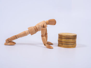 Close-up of coins on table against white background