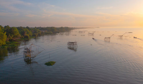 Scenic view of lake against sky during sunset