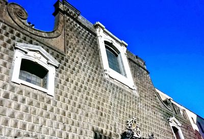 Low angle view of building against clear blue sky