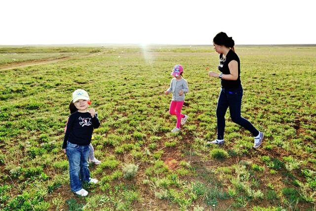 grass, lifestyles, casual clothing, leisure activity, field, full length, childhood, boys, person, elementary age, grassy, landscape, girls, standing, agriculture, clear sky, rural scene