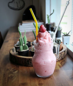 Strawberry smoothie on wooden table