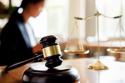 Midsection of lawyer working at desk in office