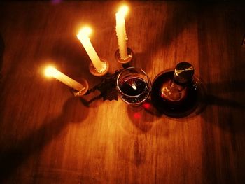 Close-up of illuminated candles on table