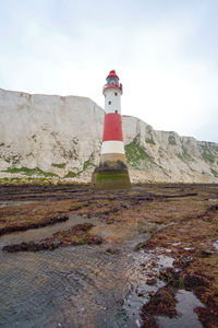 Beachy head lighthouse, seven sisters chalk cliffs at low tide near eastbourne, east sussex