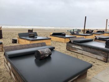 Boats on table by sea against sky