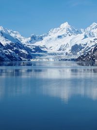 Scenic view of bay and snow covered mountains at glacier bay national park