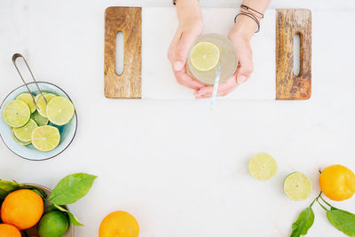 Midsection of person holding fruits on table