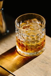 Close-up of glass with bourbon whiskey on table