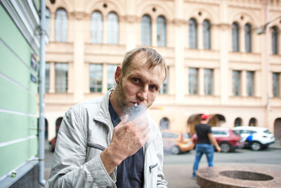 Portrait of young man in city