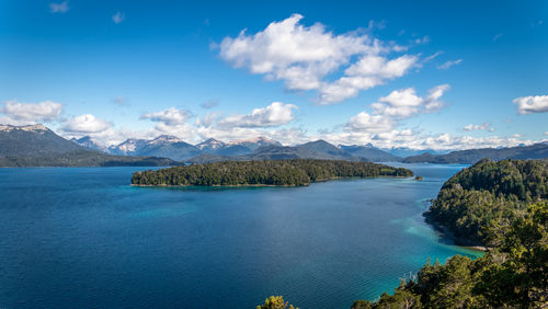 Scenic view of sea and mountains against sky