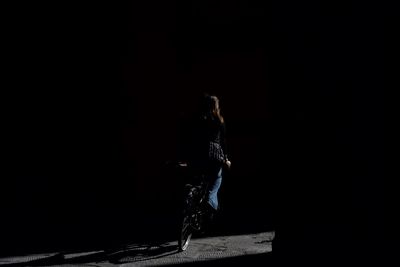 Man against black background