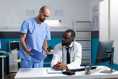 Doctor talking with male nurse at hospital