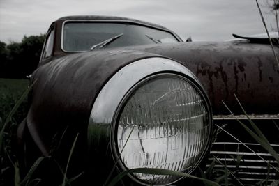 Close-up of car on road