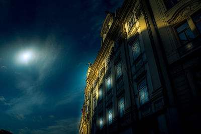 Low angle view of illuminated buildings against sky at night