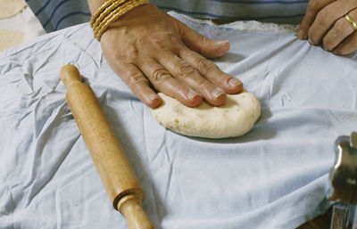 Cropped image of woman kneading dough