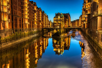 Reflection of buildings in city at night