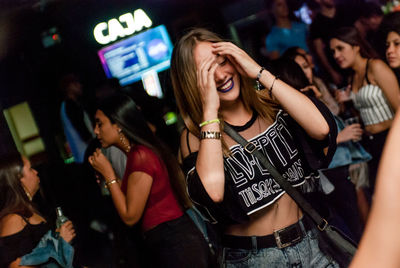 Young couple in illuminated nightclub