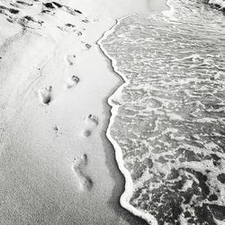 High angle view of footprints on beach