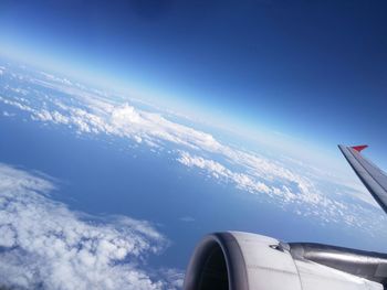 Cropped image of airplane flying over landscape