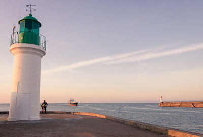 The little jetty or the skippers' jetty and the green lighthouse at les sables d'olonnes in summer