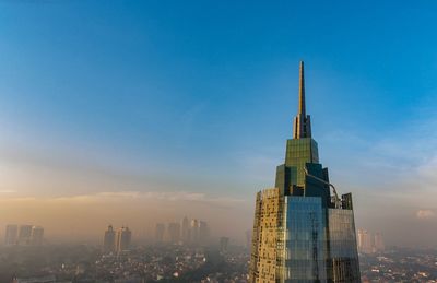 Buildings in city against blue sky