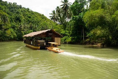 Boat in river against sky