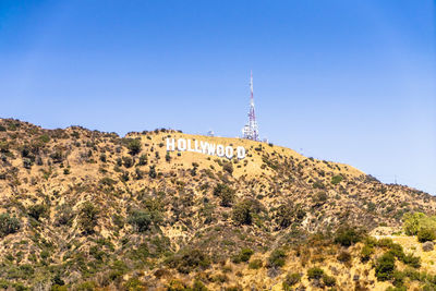 Low angle view of buildings against clear blue sky