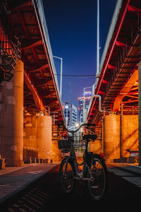 View of bridge in city against sky at night