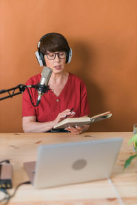 Senior woman broadcasting at studio