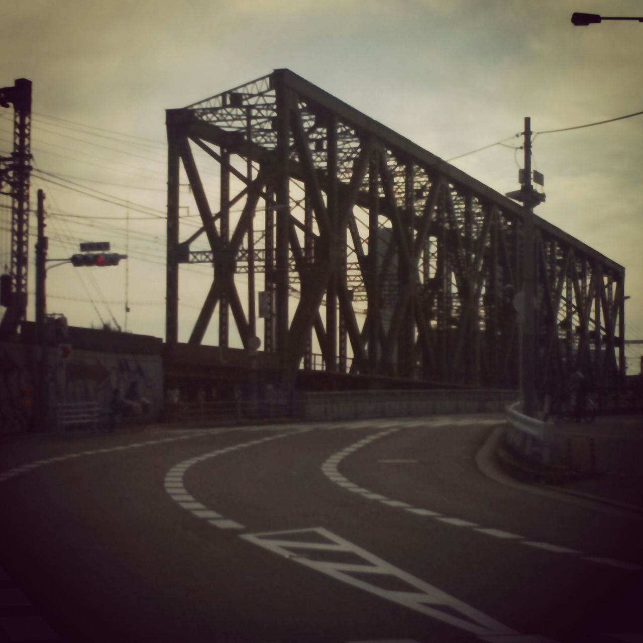 road marking, road, transportation, sky, the way forward, communication, street, road sign, text, guidance, street light, built structure, arrow symbol, western script, sign, empty, architecture, connection, cloud - sky, information sign