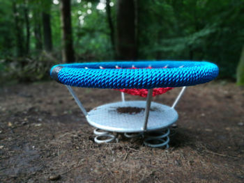 Close-up of empty chairs on table in forest