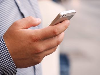 Close-up of man using mobile phone