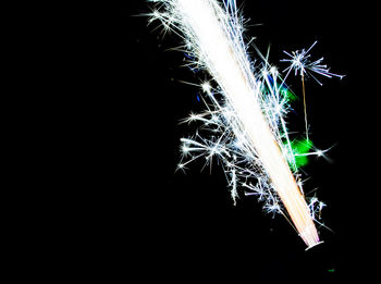 Low angle view of illuminated lights over black background