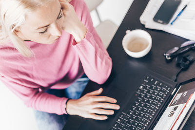 Midsection of woman using laptop