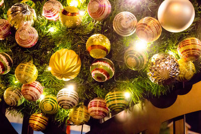 Low angle view of illuminated lanterns hanging on ceiling