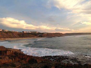 Scenic view of beach against dramatic sky