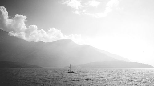 Sailboat in sea against sky