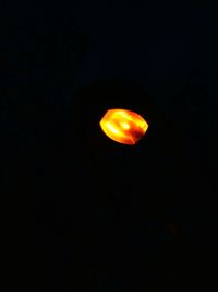 Close-up of orange moon against black background