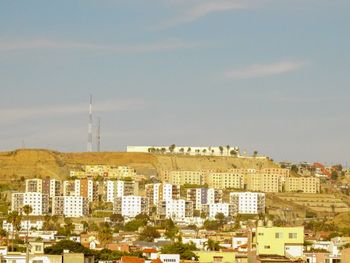 Buildings in city against sky