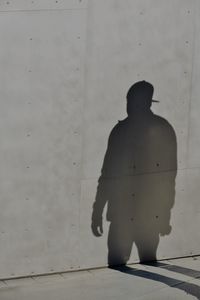 Shadow of man on gray wall