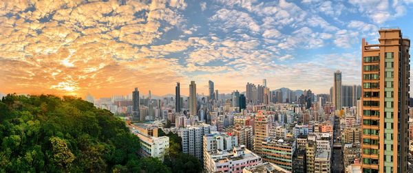 Panoramic view of city buildings against sky during sunset