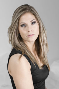 Portrait of beautiful young woman against white background