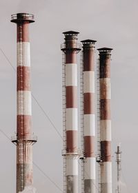 Low angle view of smoke stack against sky